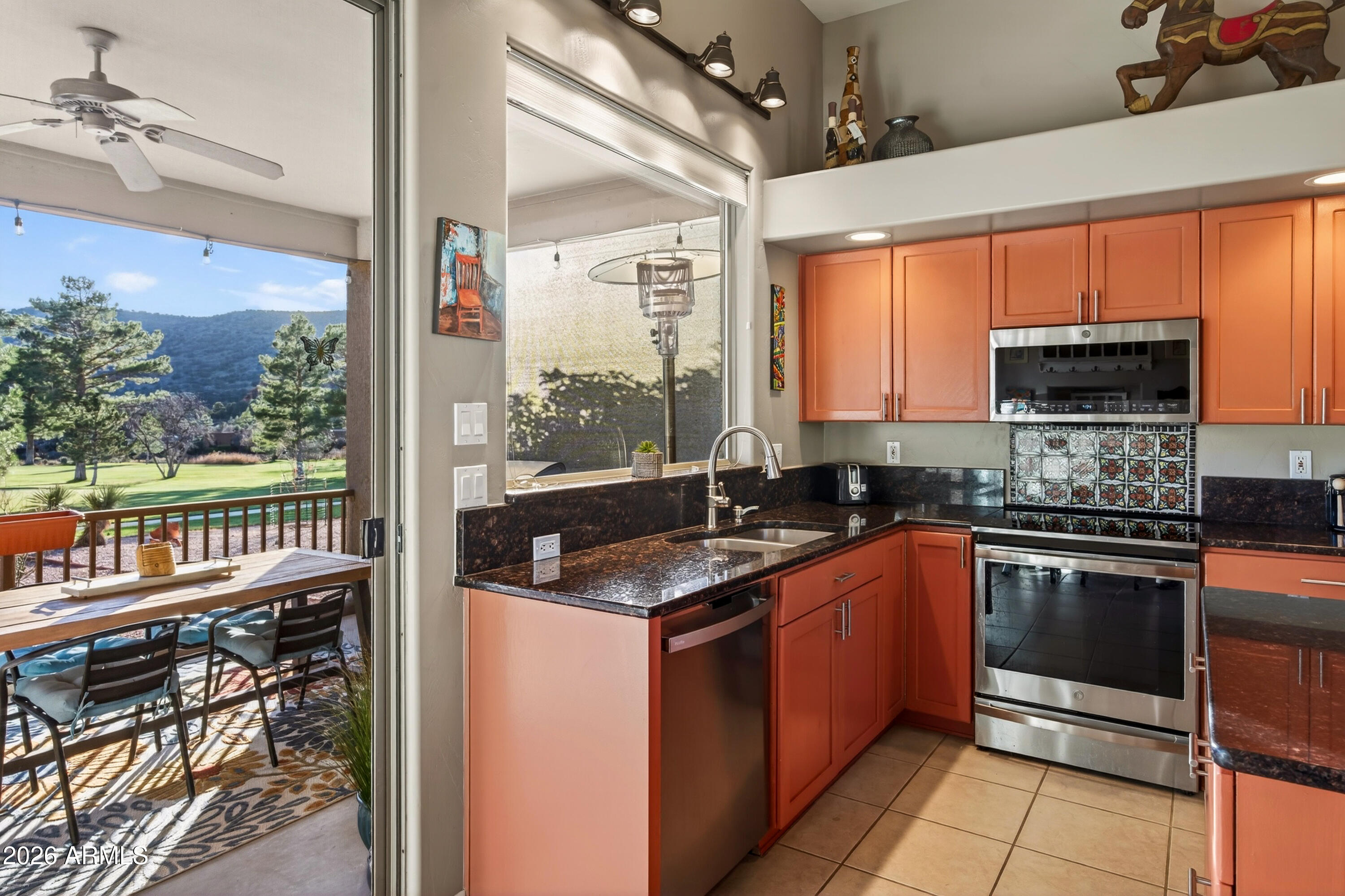 345 Merry Go Round Rock Road Sedona, AZ 86351 - Photo 11 of 43 a kitchen with stainless steel appliances granite countertop a stove a sink and a microwave