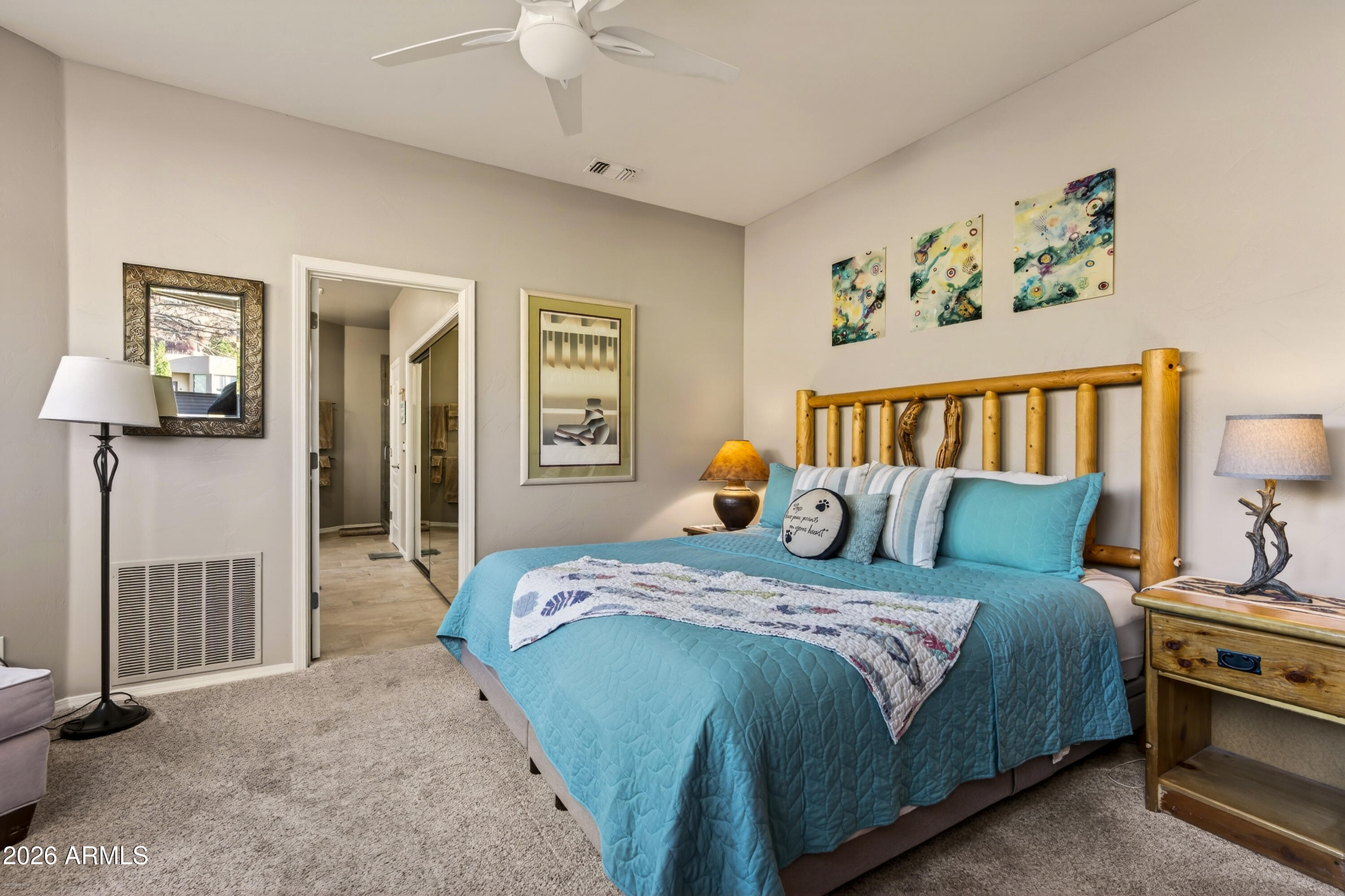 345 Merry Go Round Rock Road Sedona, AZ 86351 - Photo 14 of 43 a bedroom with a large bed and a chandelier
