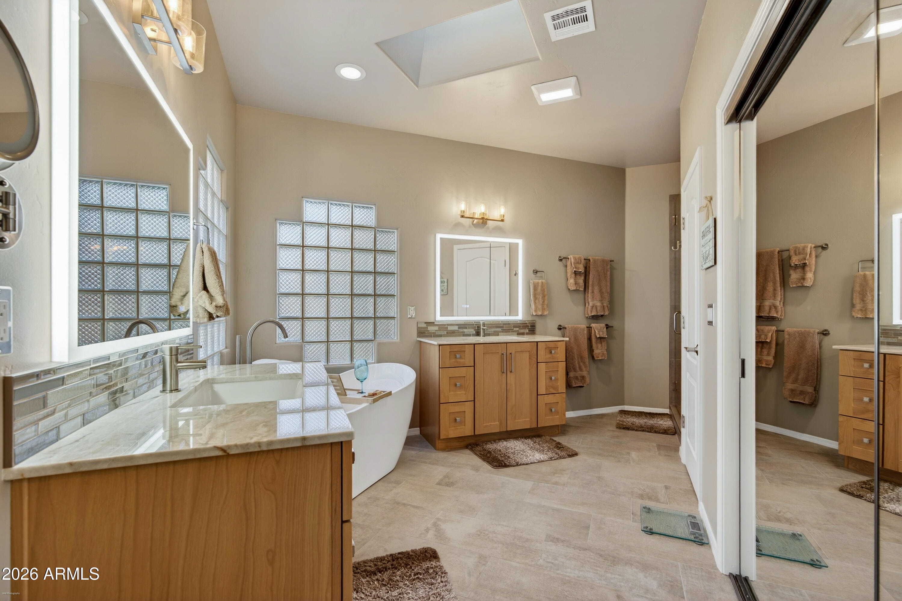 345 Merry Go Round Rock Road Sedona, AZ 86351 - Photo 17 of 43 a bathroom with a granite countertop sink mirror and a bathtub