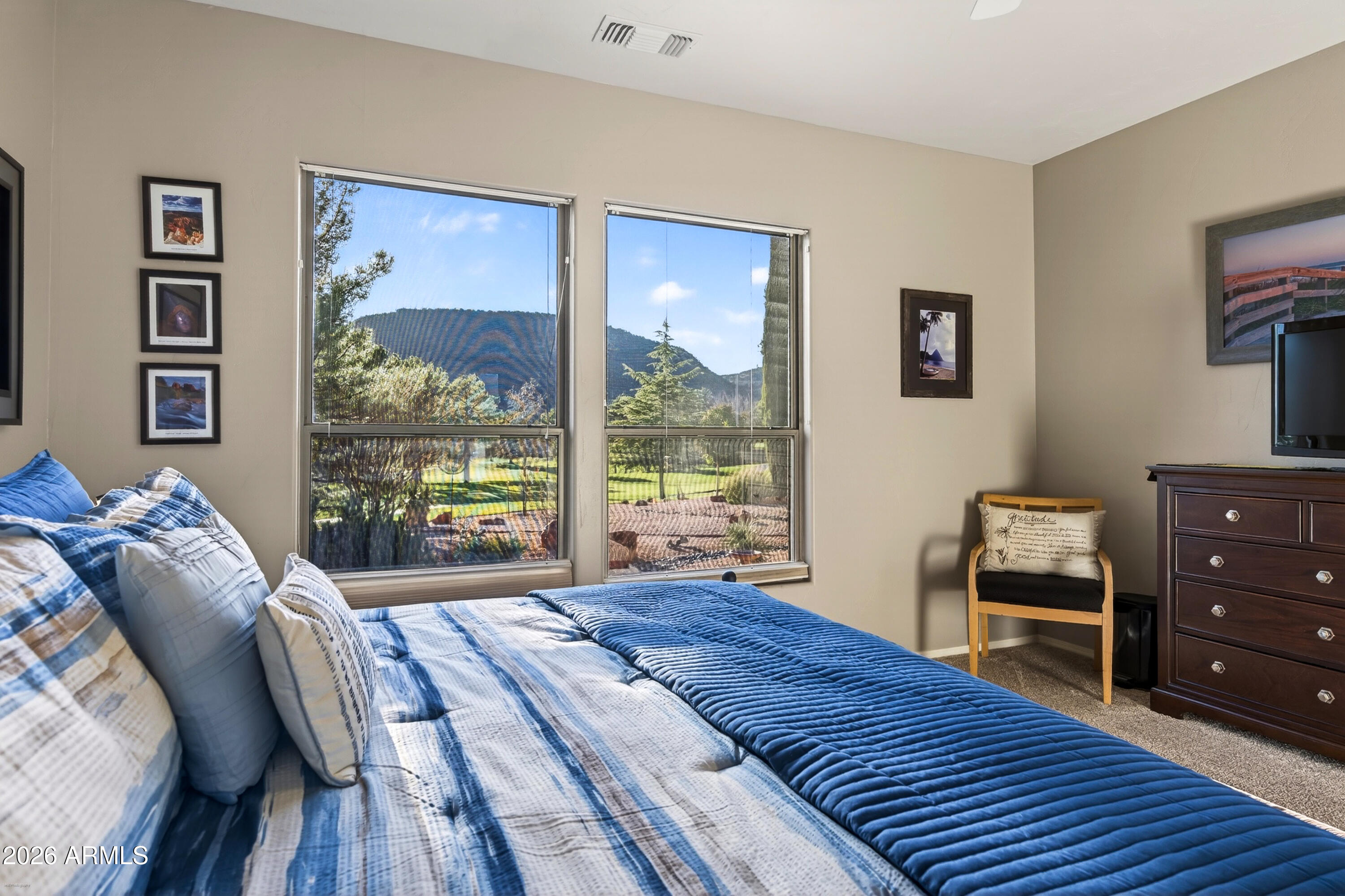 345 Merry Go Round Rock Road Sedona, AZ 86351 - Photo 21 of 43 a bedroom with a bed and a floor to ceiling window