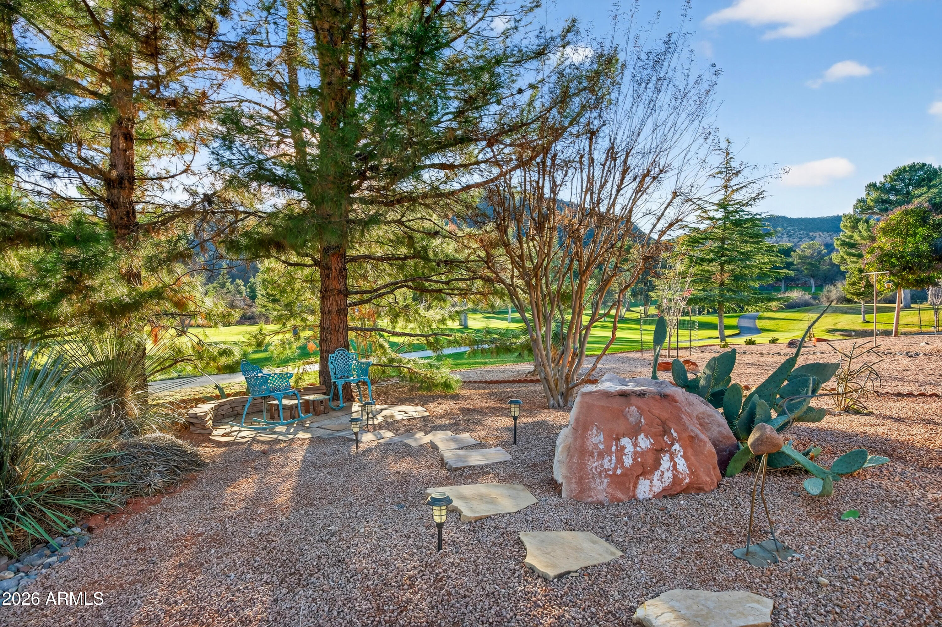345 Merry Go Round Rock Road Sedona, AZ 86351 - Photo 28 of 43 a view of a backyard with large trees