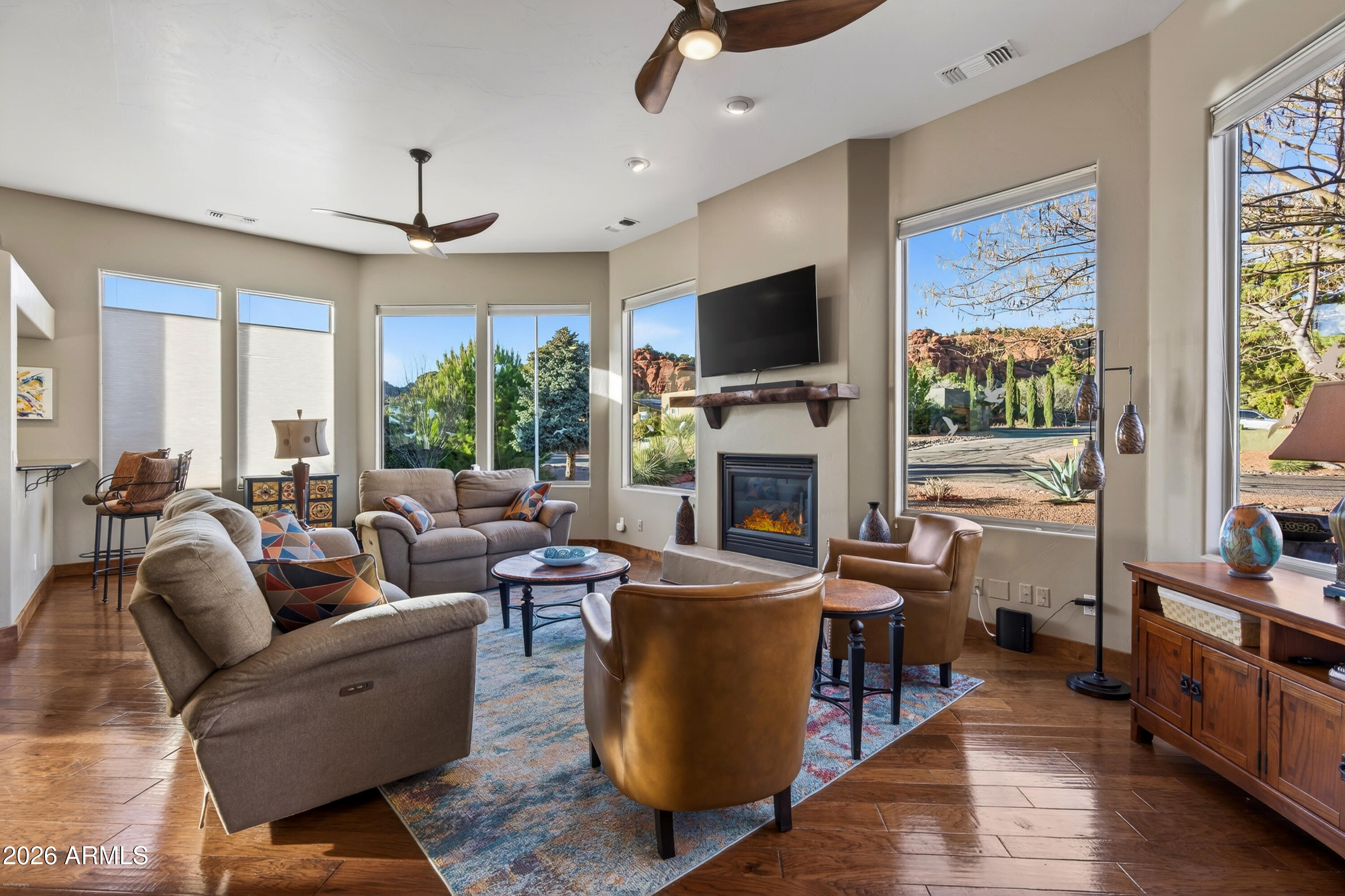 345 Merry Go Round Rock Road Sedona, AZ 86351 - Photo 5 of 43 a living room with furniture a fireplace and a flat screen tv