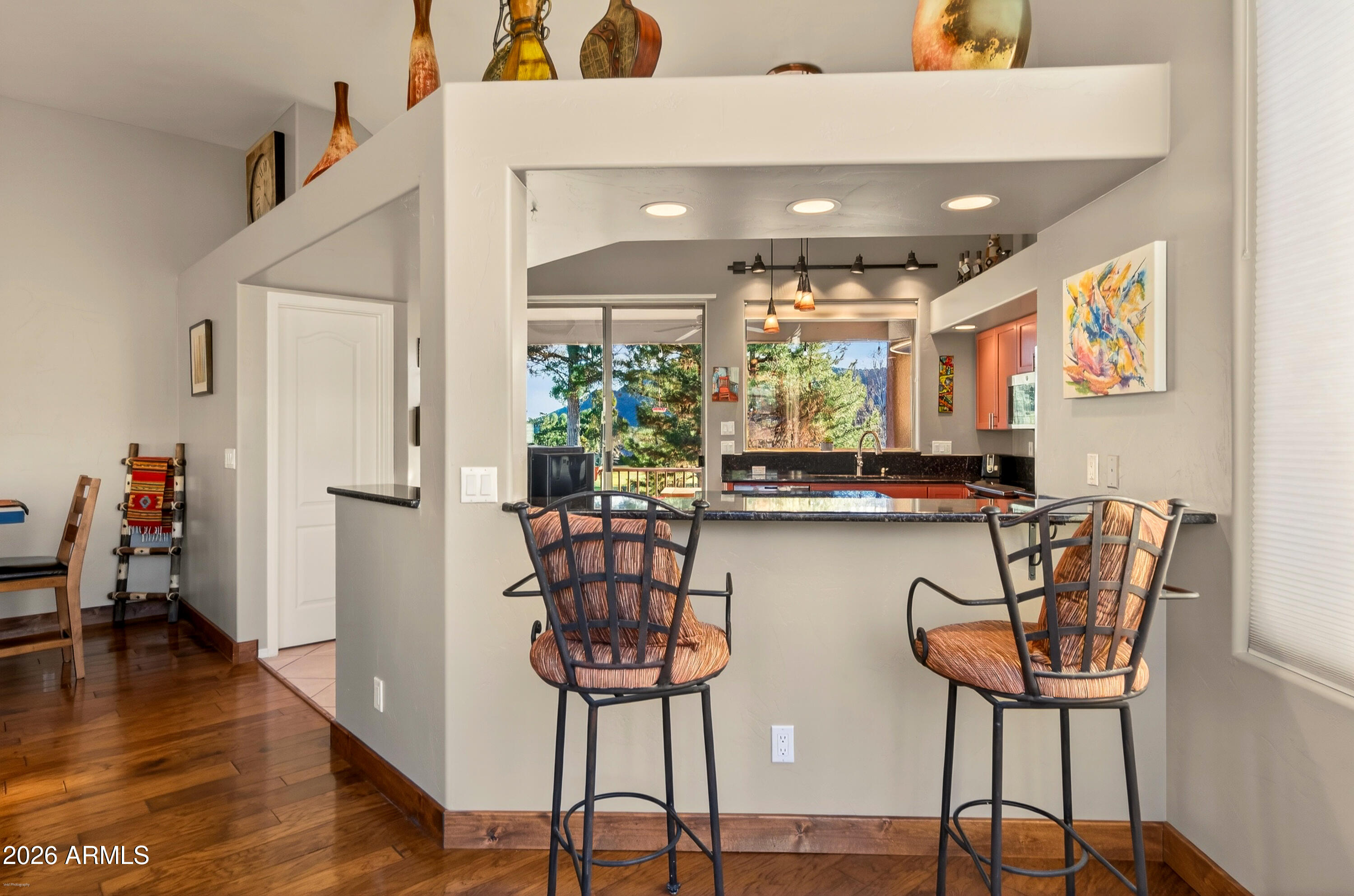 345 Merry Go Round Rock Road Sedona, AZ 86351 - Photo 8 of 43 a dining room with furniture and wooden floor