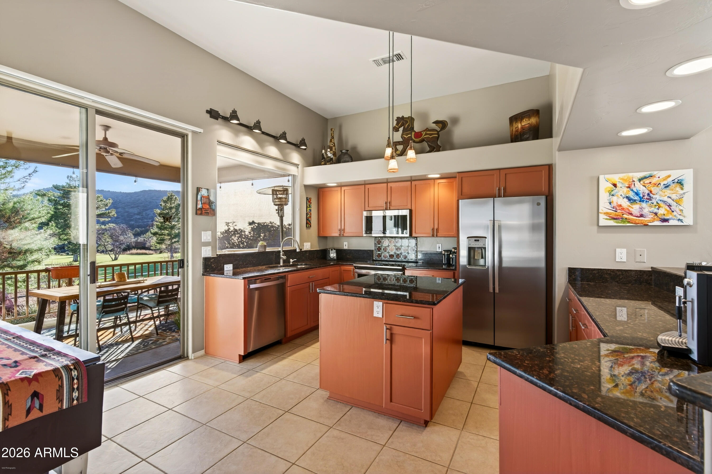 345 Merry Go Round Rock Road Sedona, AZ 86351 - Photo 9 of 43 a kitchen with stainless steel appliances granite countertop a sink and a refrigerator