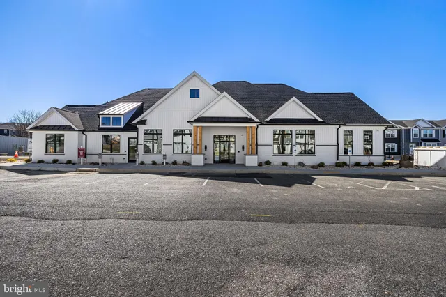 a view of a house with a big yard and large trees