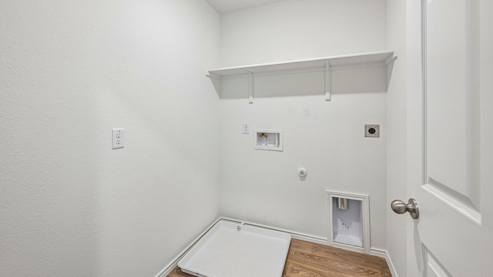 369 Old Stage Coach Road Jarrell, TX 76537 - Photo 22 of 25 Functional utility space includes built-in shelving and durable wood-look flooring.