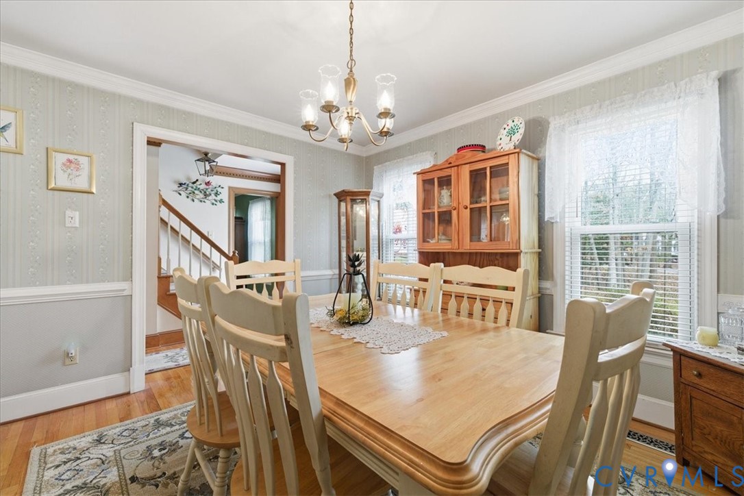 14110 Howlett Line Drive Colonial Heights, VA 23834 - Photo 13 of 44 a dining room with wooden floor a chandelier a wooden table and chairs