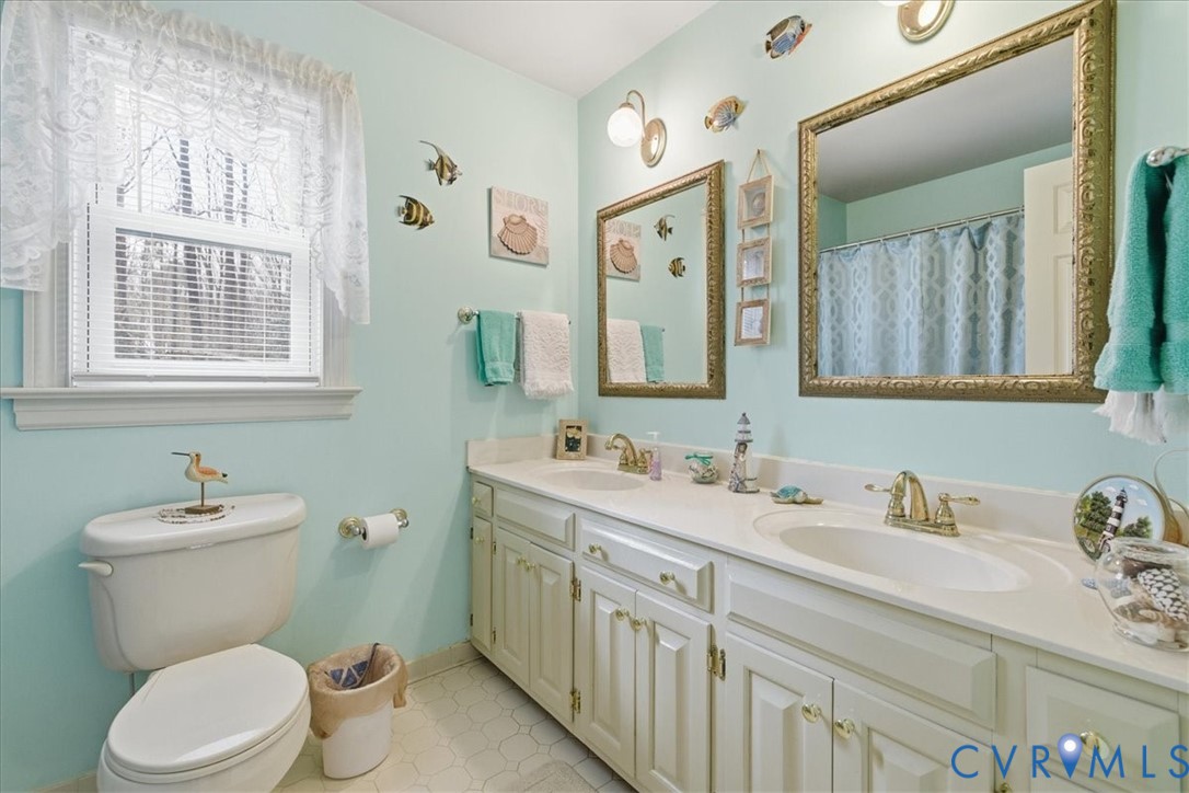 14110 Howlett Line Drive Colonial Heights, VA 23834 - Photo 22 of 44 a bathroom with a toilet sink and mirror