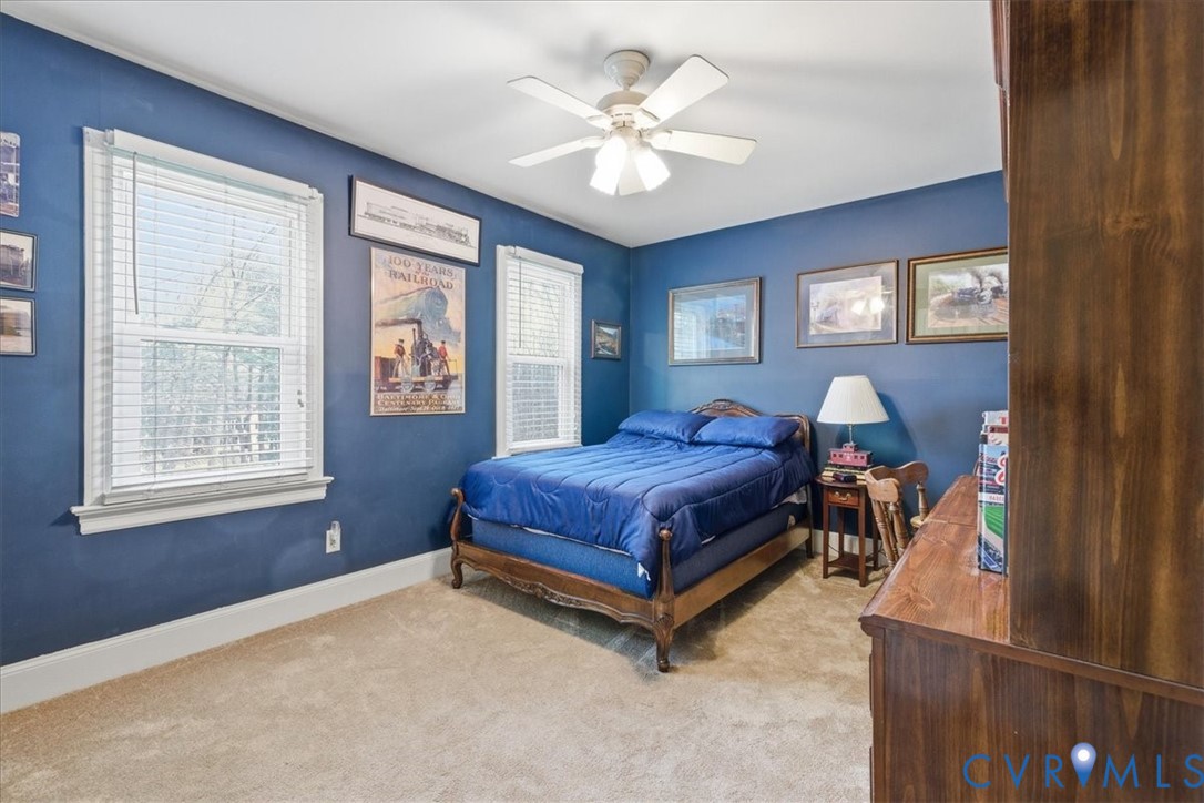 14110 Howlett Line Drive Colonial Heights, VA 23834 - Photo 23 of 44 a spacious bedroom with a bed and a chandelier