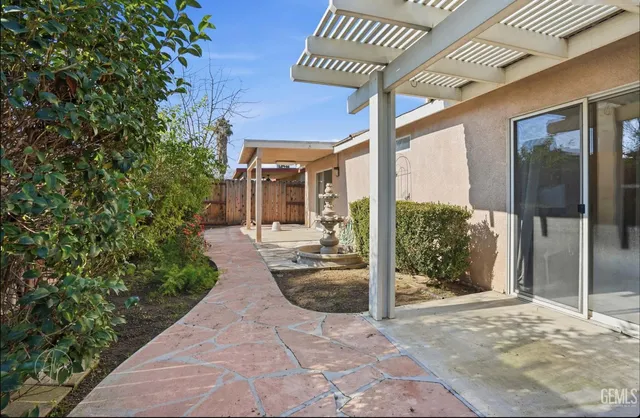 a view of a porch with furniture and floor to ceiling window