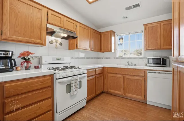 a kitchen with stainless steel appliances granite countertop a stove and a sink