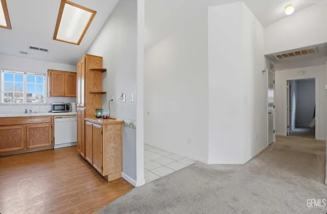 a kitchen with sink cabinets and wooden floor