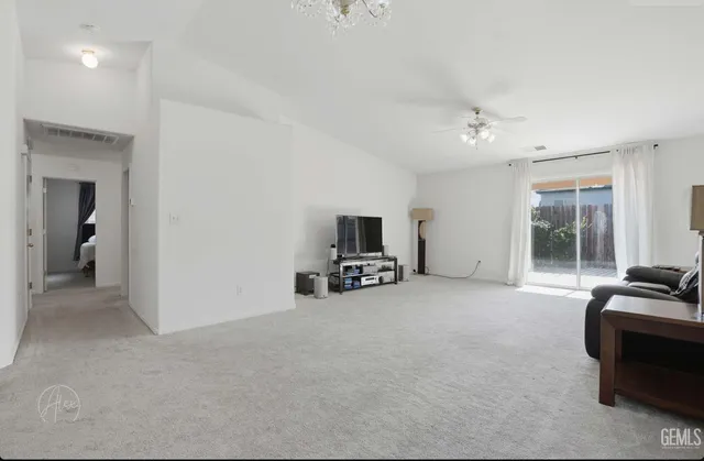 a view of a livingroom with furniture and a flat screen tv