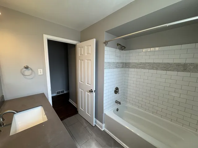 a bathroom with a bathtub and a shower