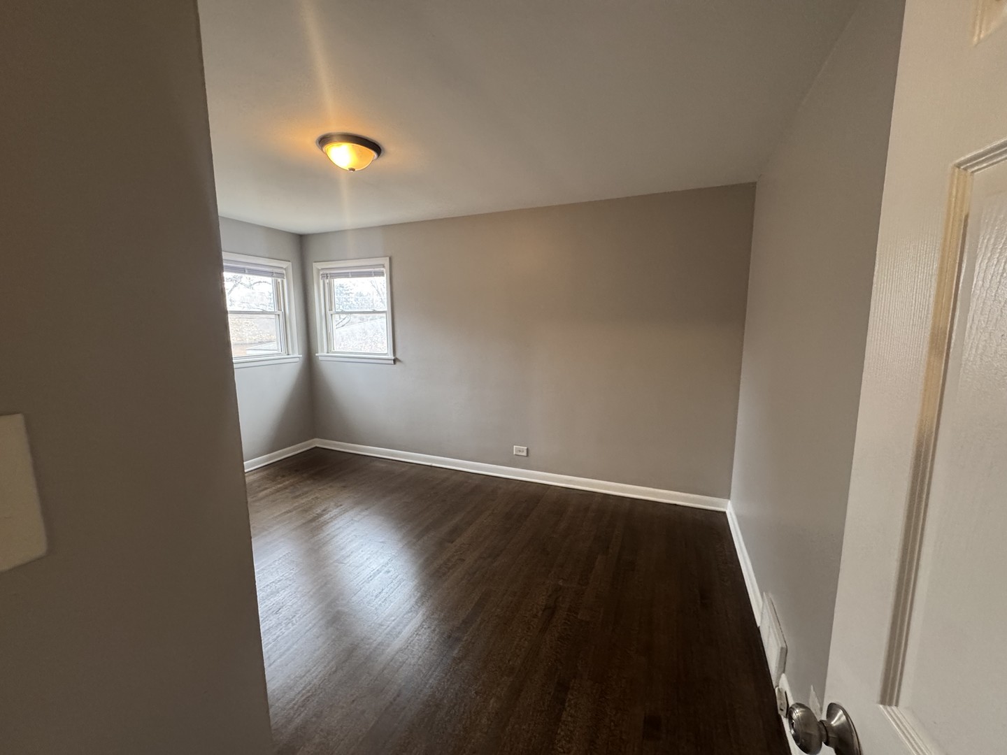 15125 East End Avenue Dolton, IL 60419 - Photo 12 of 21 an empty room with wooden floor and windows