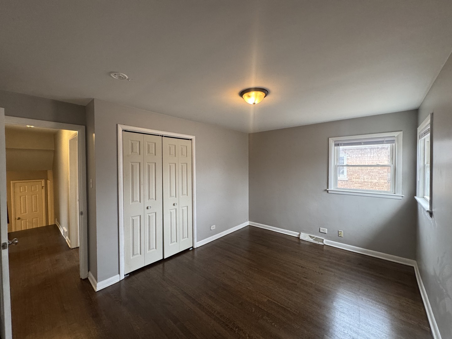 15125 East End Avenue Dolton, IL 60419 - Photo 14 of 21 an empty room with wooden floor and windows