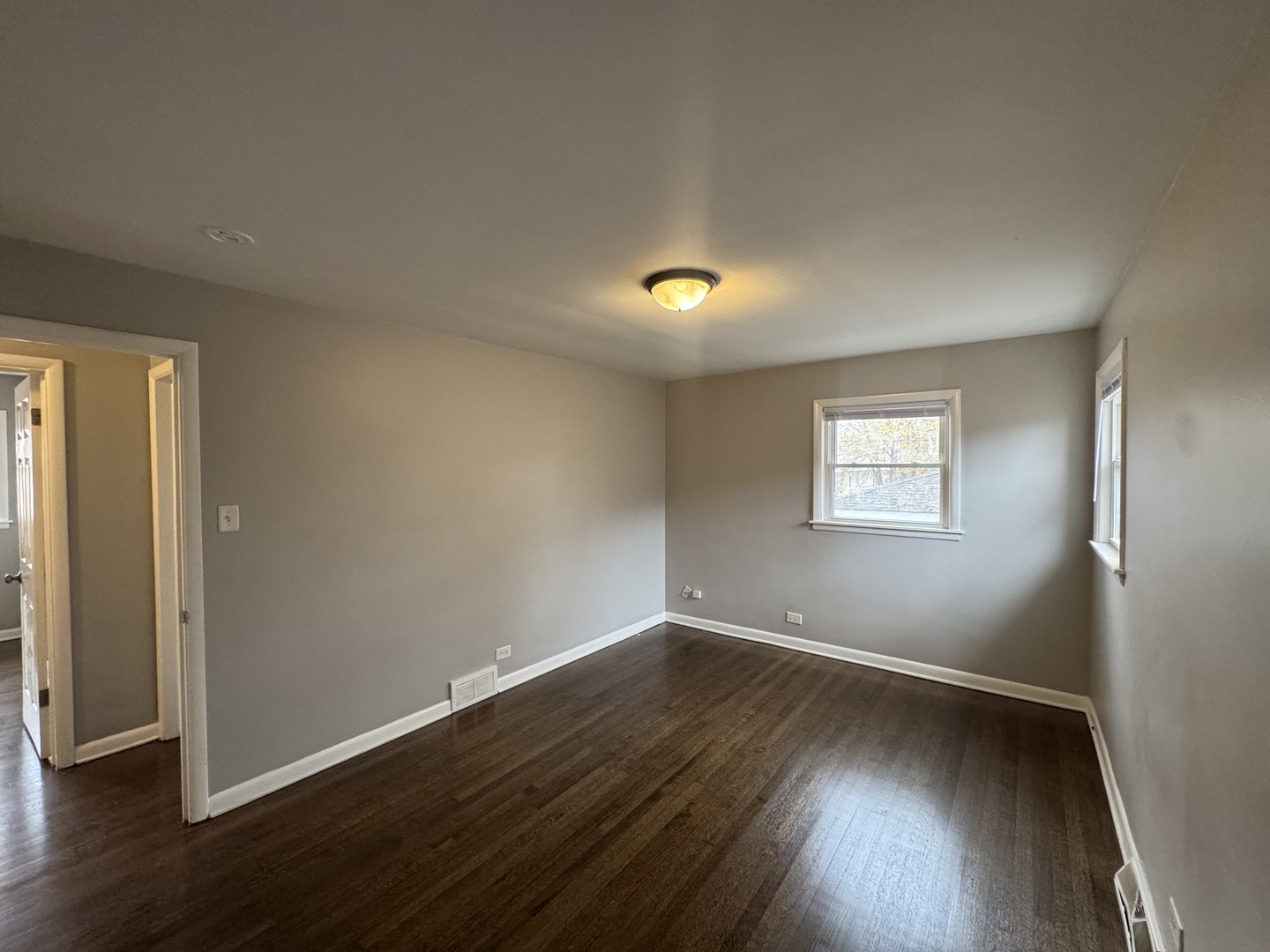 15125 East End Avenue Dolton, IL 60419 - Photo 15 of 21 a view of an empty room with wooden floor and a window