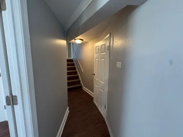 a view of a hallway with stairs