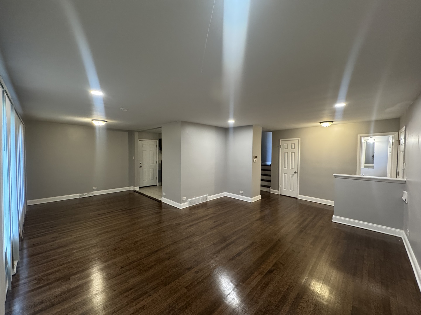 15125 East End Avenue Dolton, IL 60419 - Photo 3 of 21 a view of an empty room with wooden floor and a window