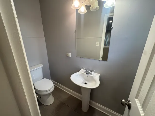 a bathroom with a sink toilet and mirror