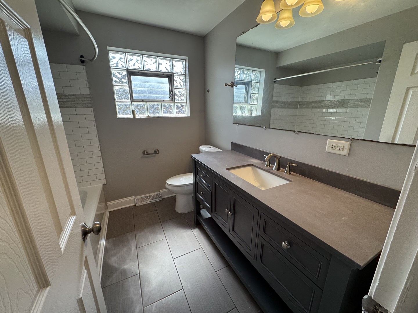 15125 East End Avenue Dolton, IL 60419 - Photo 10 of 21 a spacious bathroom with a double vanity sink toilet and a tub