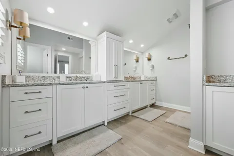 a bathroom with a granite countertop sink mirror and