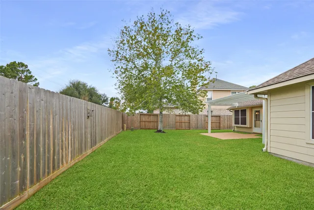 a view of an house with backyard and porch