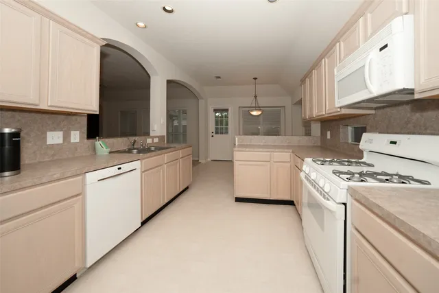 a kitchen with granite countertop cabinets stainless steel appliances and a window