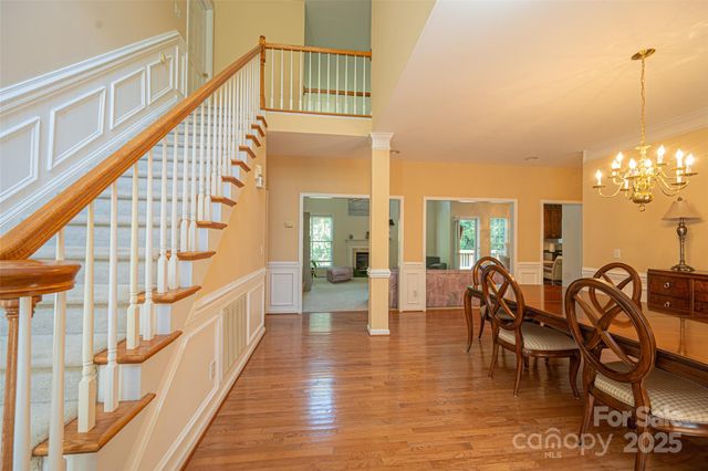 a view of an entryway wooden floor and dining room view
