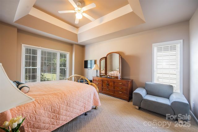 a bedroom with a bed couch and window