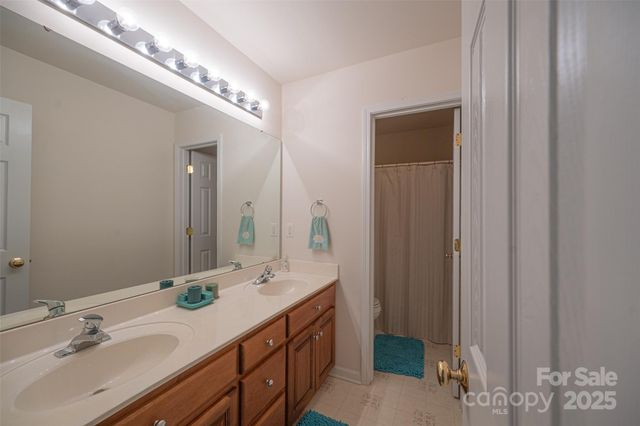 a bathroom with a double vanity sink and a mirror