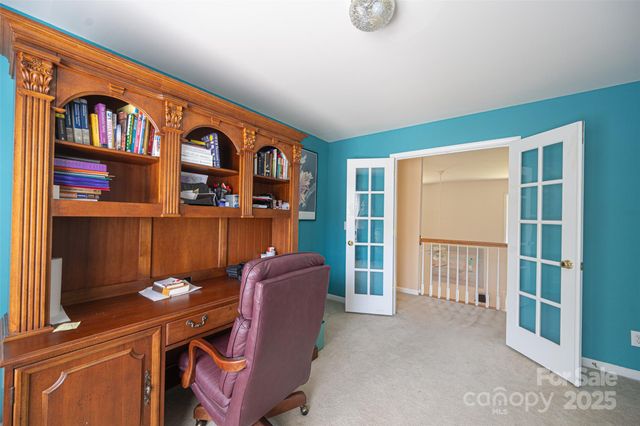 a room with furniture a bookshelf and a window