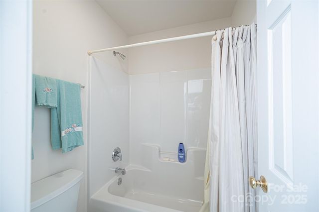 a bathroom with a shower and a bath tub