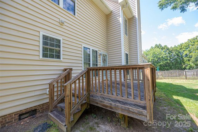 a view of a house with a wooden deck