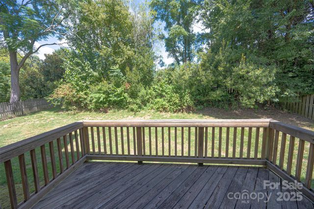 a balcony with wooden floor and fence