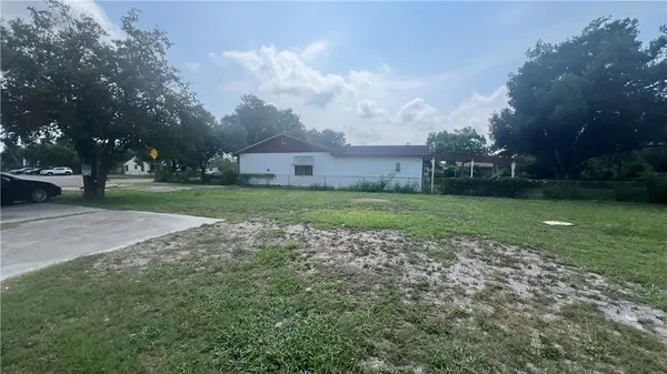 a view of a big yard with a house