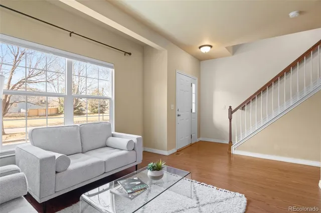 a living room with furniture and a large window