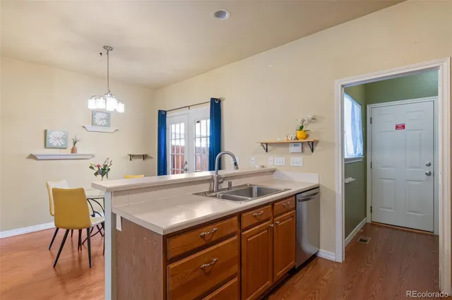 a kitchen with a table chairs refrigerator and cabinets