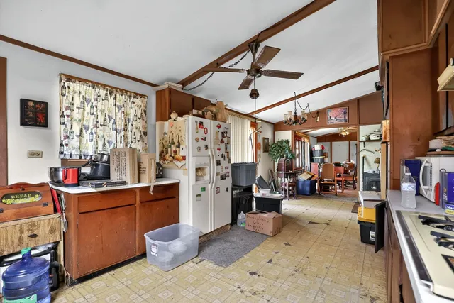 a view of a livingroom with workspace and a window