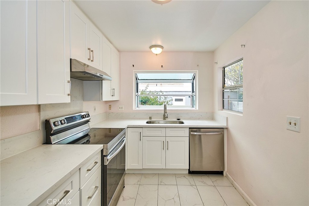 23507 Twin Spring Lane Diamond Bar, CA 91765 - Photo 5 of 27 a kitchen with a sink stove and cabinets