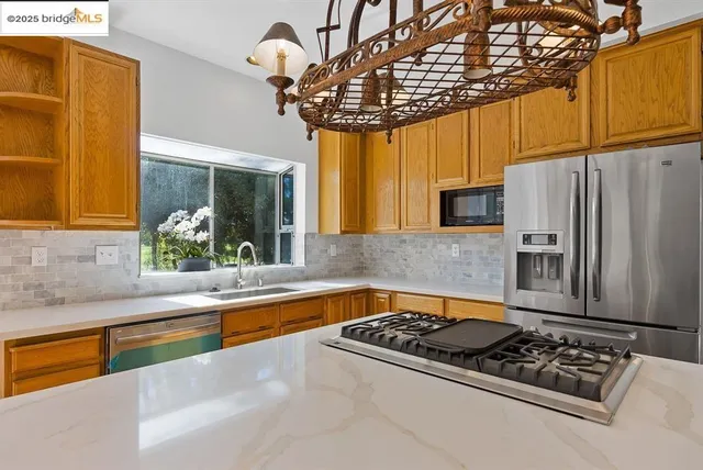 a kitchen with a sink appliances and cabinets
