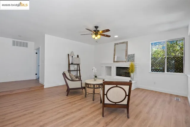 a view of a room with furniture wooden floor and window