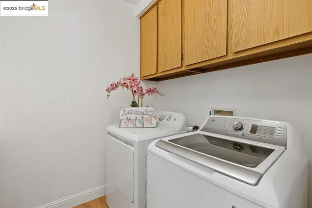 a view of a livingroom with a fireplace wooden floor and chandelier