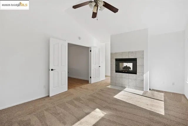 a view of a livingroom with a fireplace and window