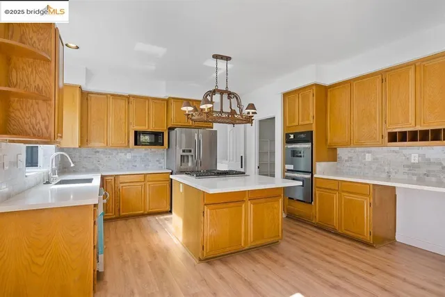 a kitchen with wooden floors and wooden cabinets