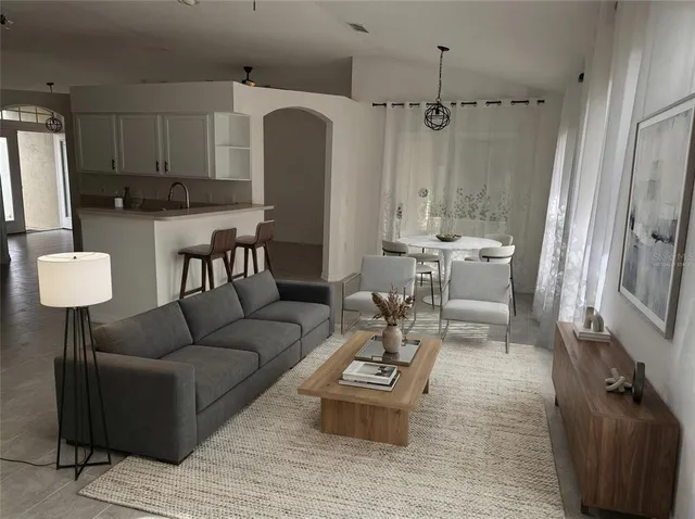 a living room with furniture and a chandelier