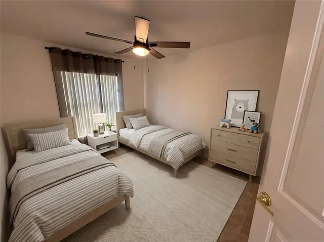 a bedroom with two beds and a chandelier