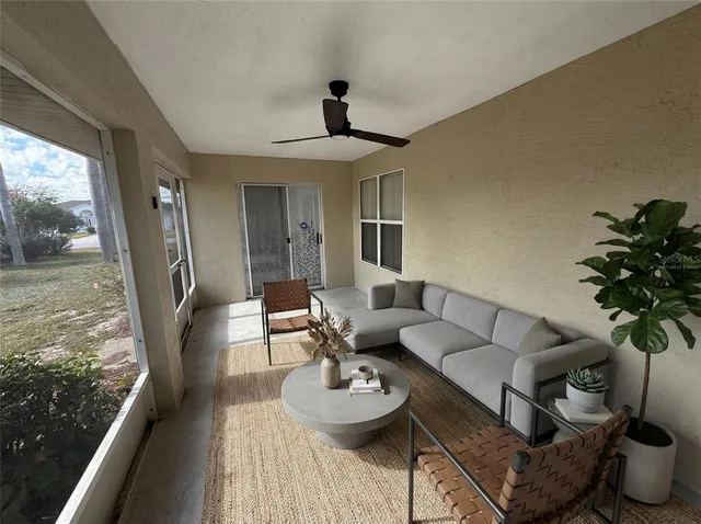 a living room with furniture and a floor to ceiling window
