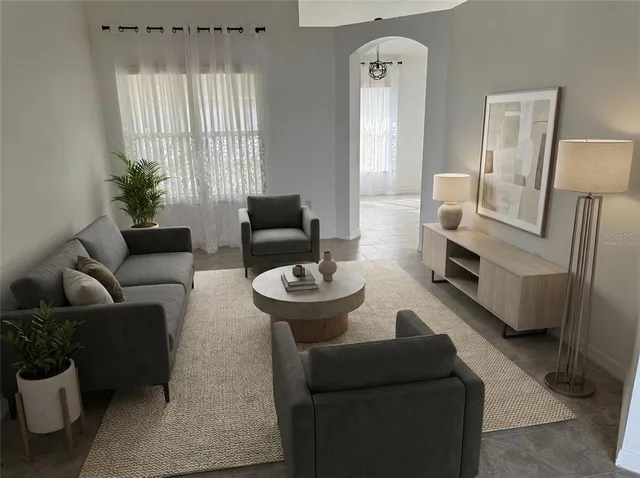 a living room with furniture and a large window