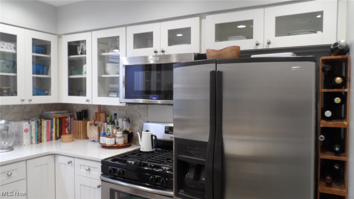 2542 Carson Road Fairlawn, OH 44333 - Photo 3 of 28 Kitchen featuring white cabinetry, stainless steel appliances, and backsplash
